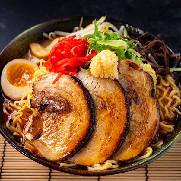 Shinjiru Ramen's ramen bowl with sliced pork, egg, noodles, and various toppings.